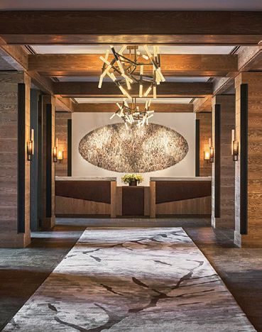 The lobby entrance with timber beams and a sculptural chandelier