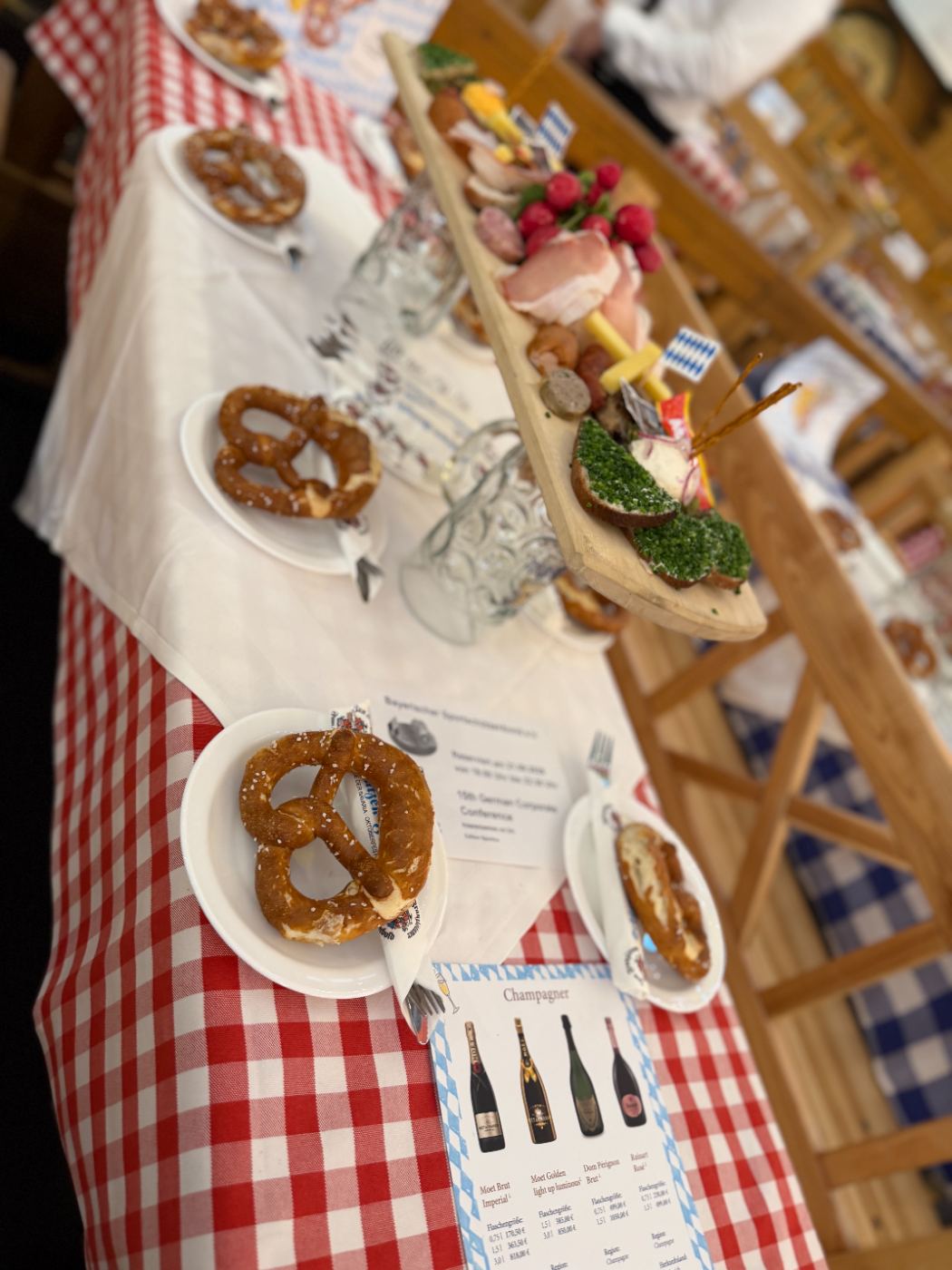 A tent table set with Brezn and a Brotzeit board